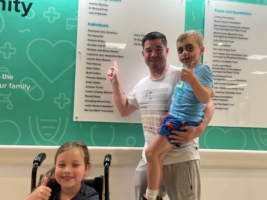 Family in front of donor recognition wall